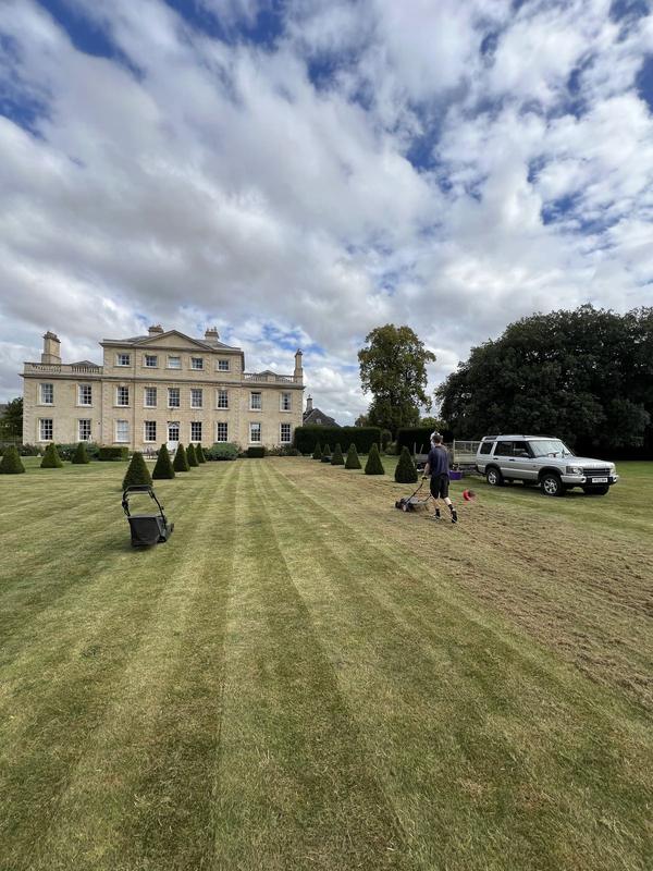 Freshly striped lawn in front of a country house
