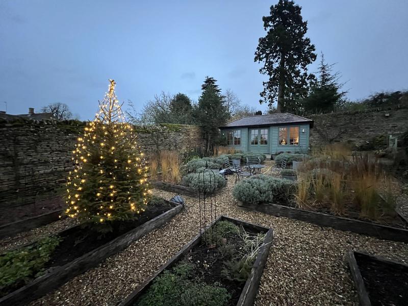 Walled kitchen garden with raised beds and gravel paths in winter